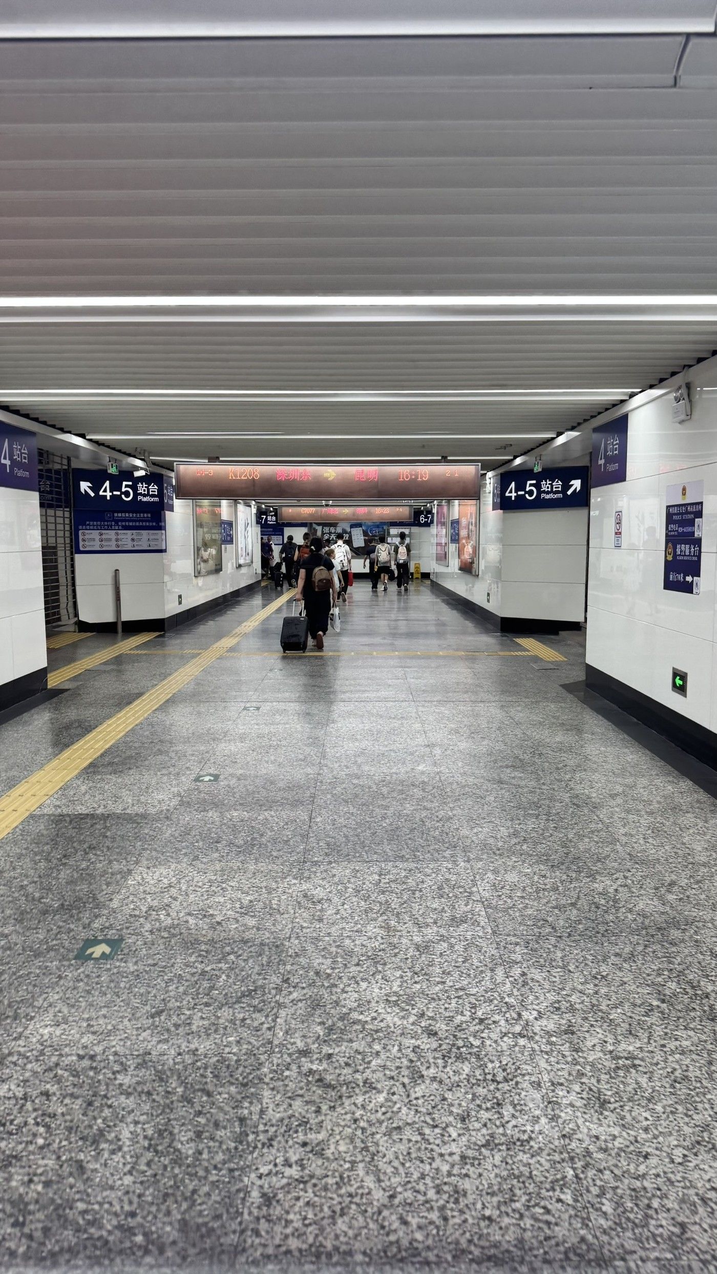 Underground corridor toward the platform with bilingual signage